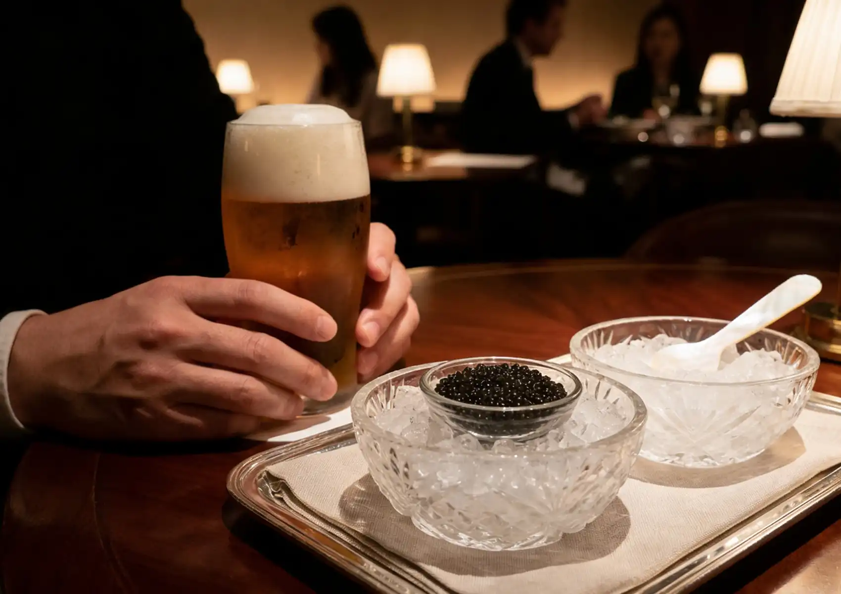 Siberian Sturgeon caviar served on ice with beer pairing at a luxury dining table.