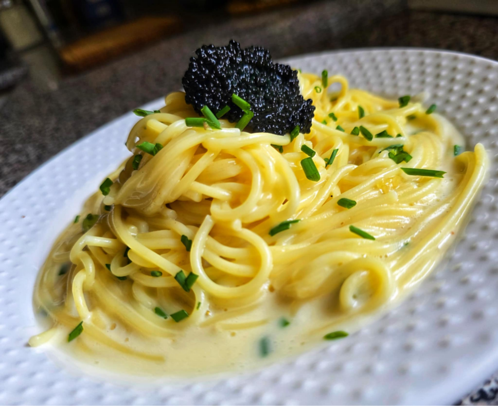 Spaghetti with a creamy sauce and caviar on top