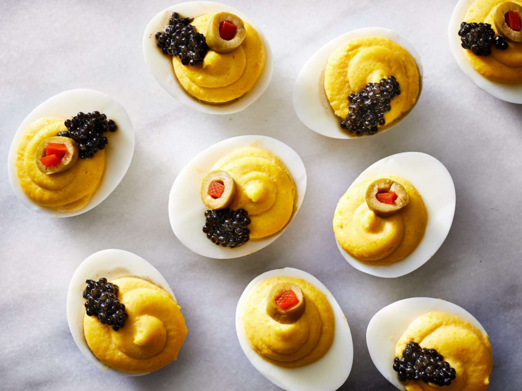 Canapés with caviar and olives on top