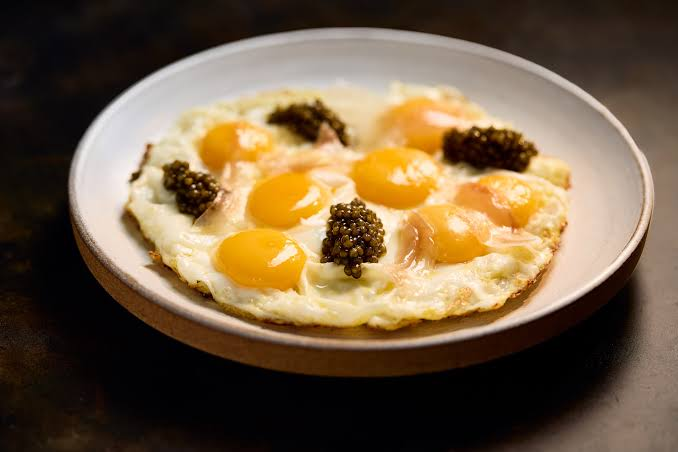 Fried eggs with caviar